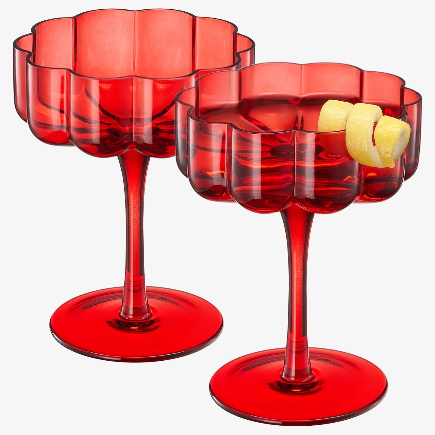 Two red wavy glass cocktail coupes, close view with lemon slice garnish