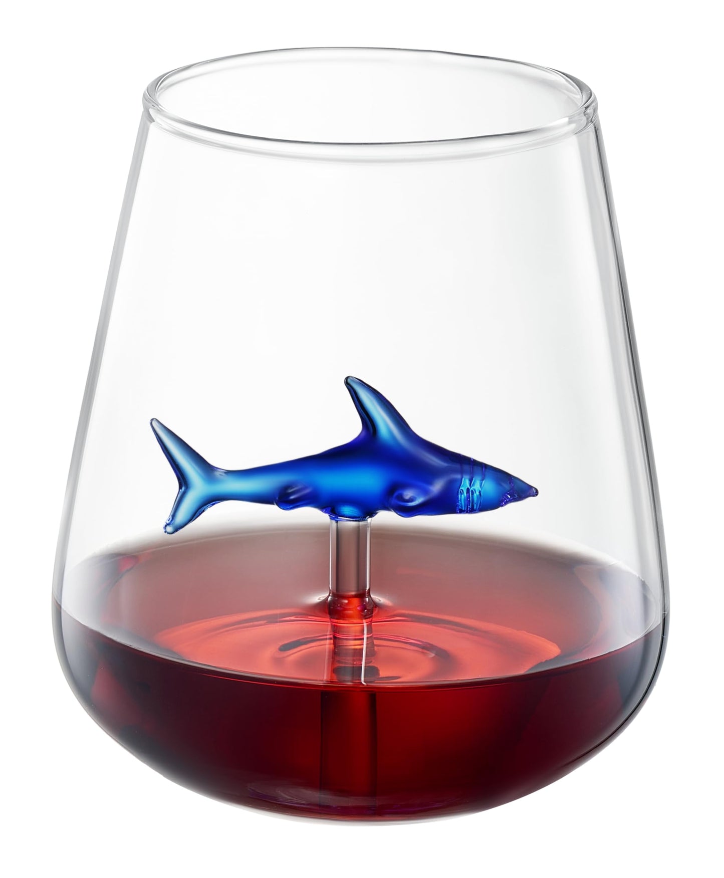 Stemless wine glass with blue shark decal and red wine at the base