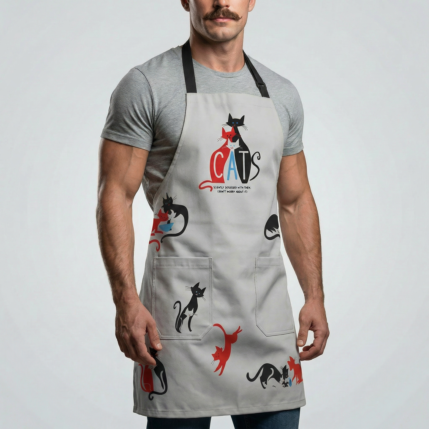 Light gray unisex apron with cat pattern, front pockets, and “CATS” logo