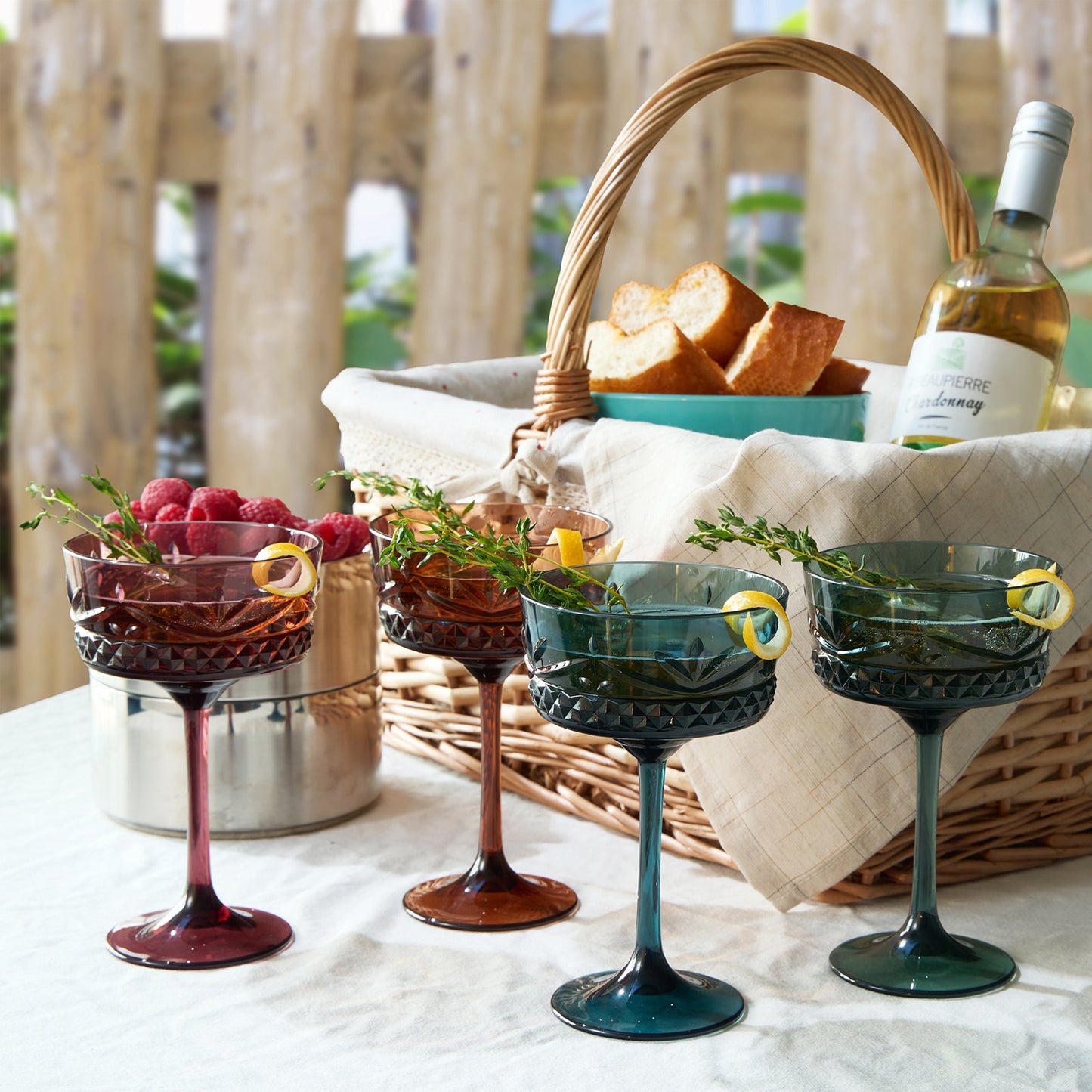 Set of 4 cocktail coupe glasses with faceted crystal-style bowls in dark red, amber, green, blue