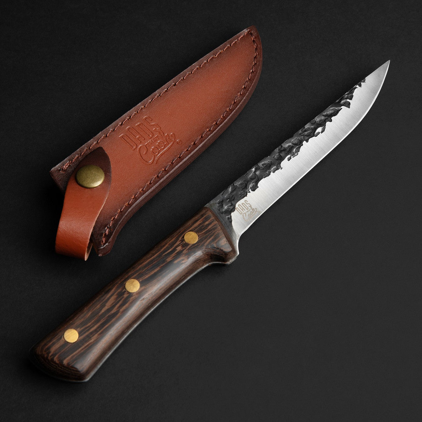 Stainless BBQ knife with dark wood handle and brown leather sheath, side view