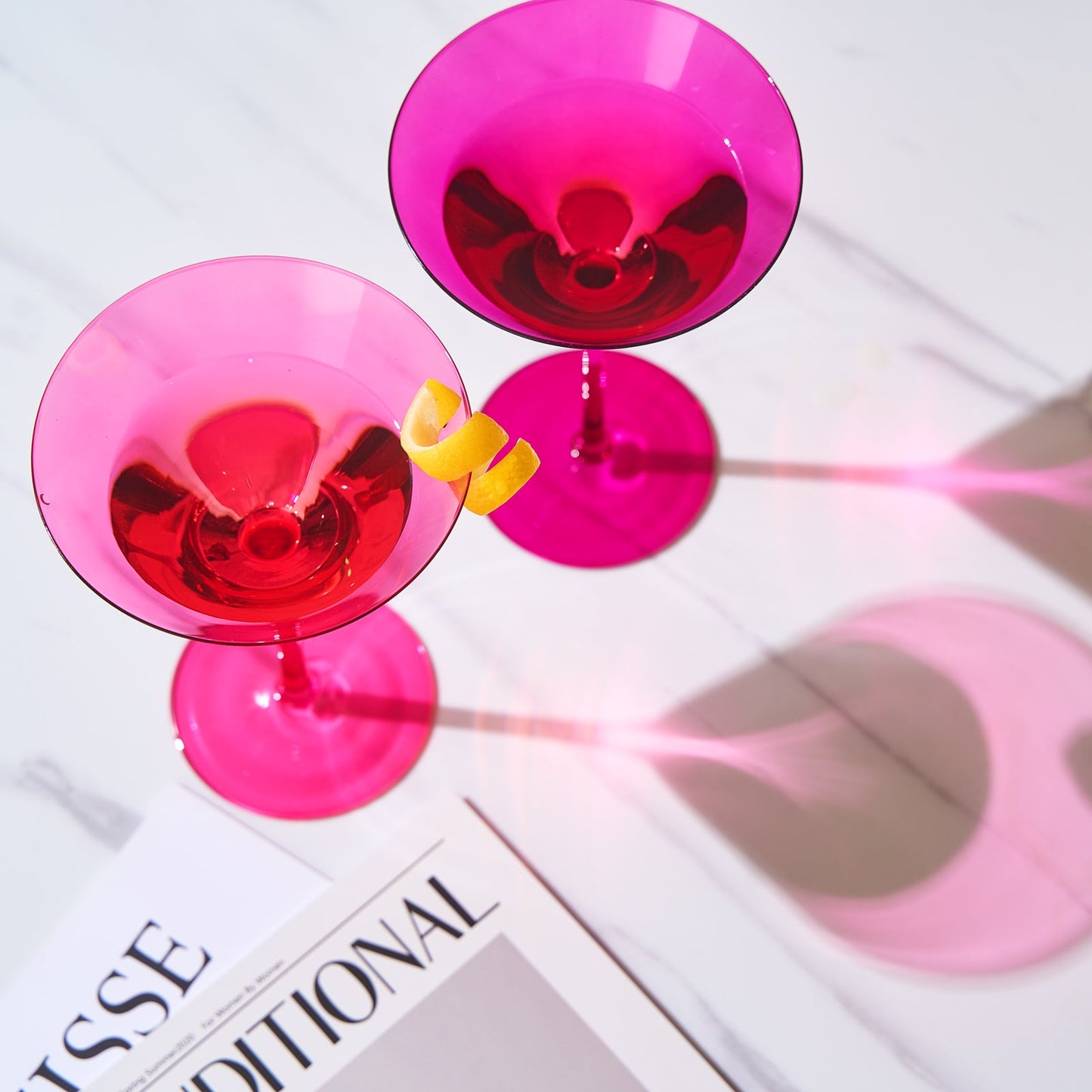 Top view of magenta martini cocktail glasses set of 2 with citrus garnish