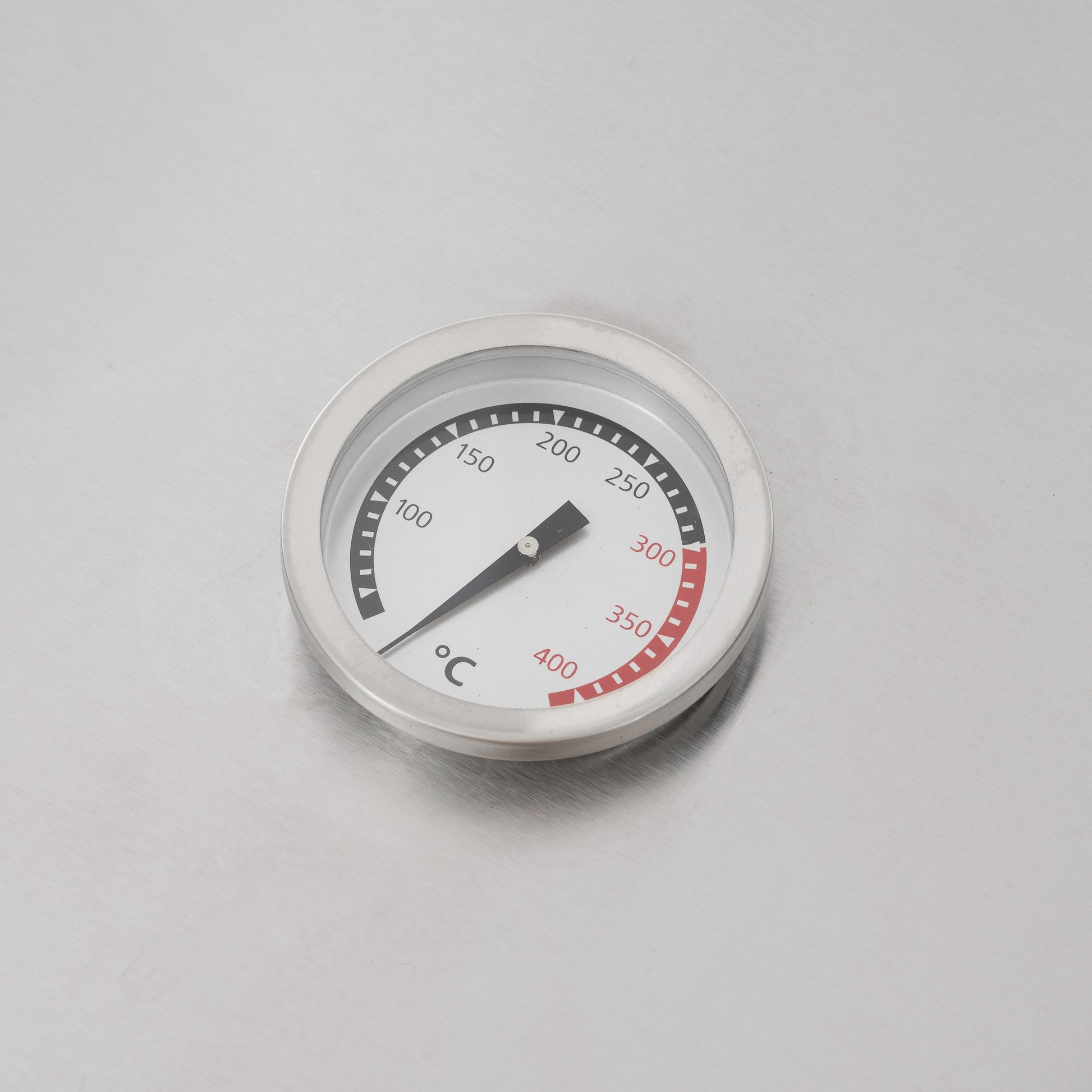 Round temperature gauge for gas grill with °C dial markings and red range