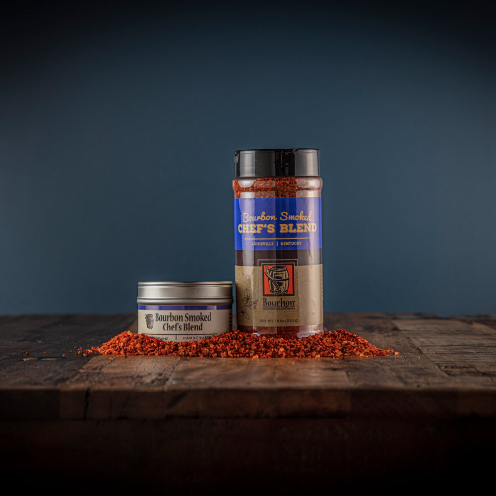 Spice blend jars with red-orange seasoning and blue-and-cream labels, one with open lid