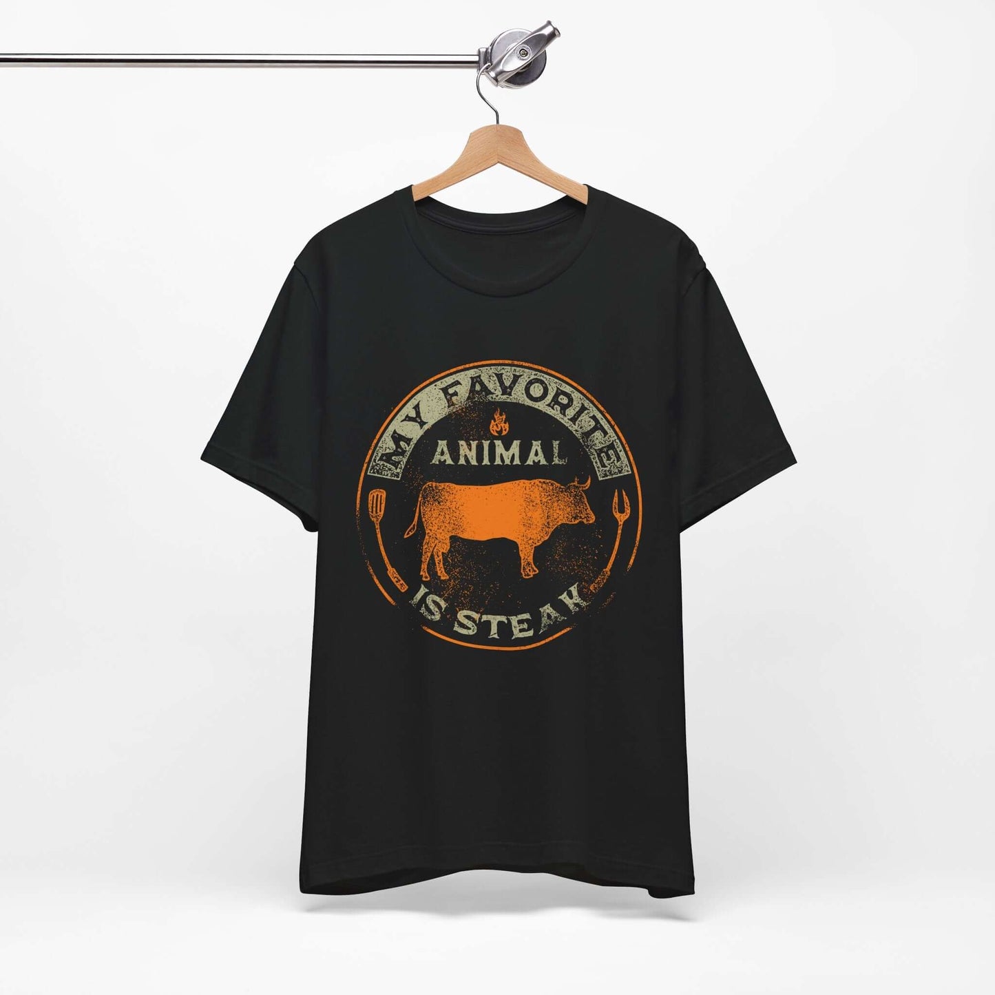 Black T-shirt on hanger with orange and tan round animal steak logo graphic