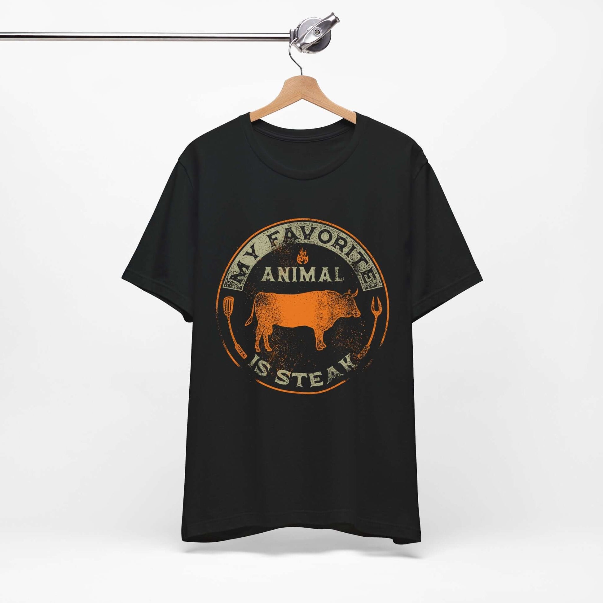 Black T-shirt on hanger with orange and tan round animal steak logo graphic