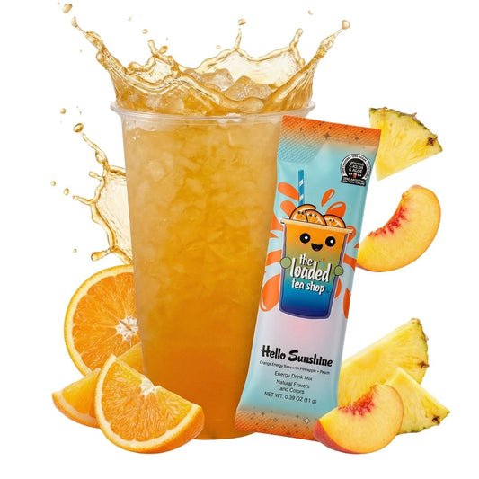 Iced peach-pineapple loaded tea in a clear cup with fruit slices and tea stick pouch
