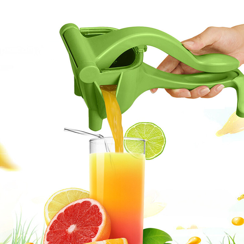 Green hand citrus juicer with lever and spout, dispensing juice into a cup