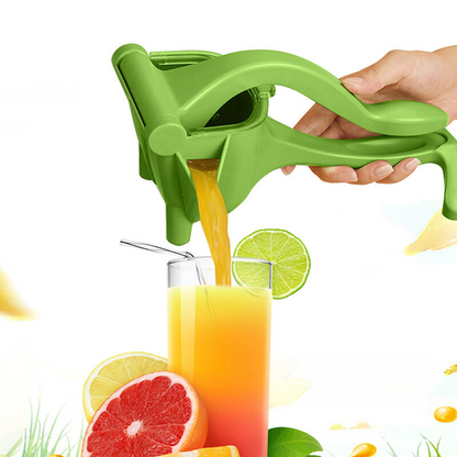 Green hand citrus juicer with lever and spout, dispensing juice into a cup