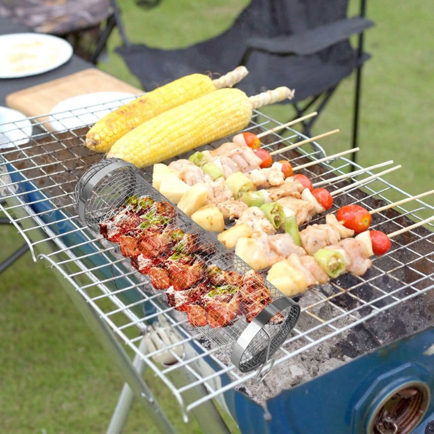 Two round stainless mesh BBQ baskets on grill with corn and meat
