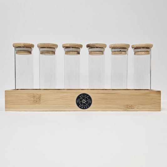 Glass storage tube set with cork lids in light wood rack, six clear tubes