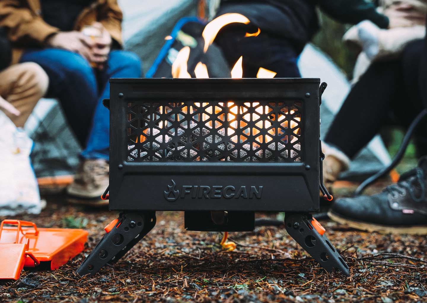 FireCan rocks set in fire pit with flames and vented front panel