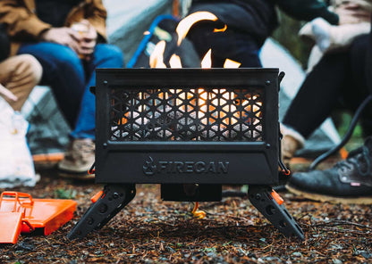 FireCan rocks set in fire pit with flames and vented front panel