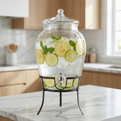 Glass beverage dispenser with clear lid and metal stand, filled with lemon and mint