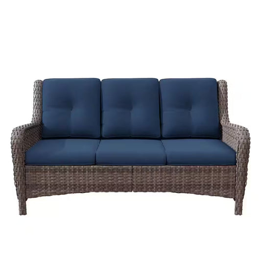 3-seat wicker sofa with dark blue tufted cushions and thick armrests
