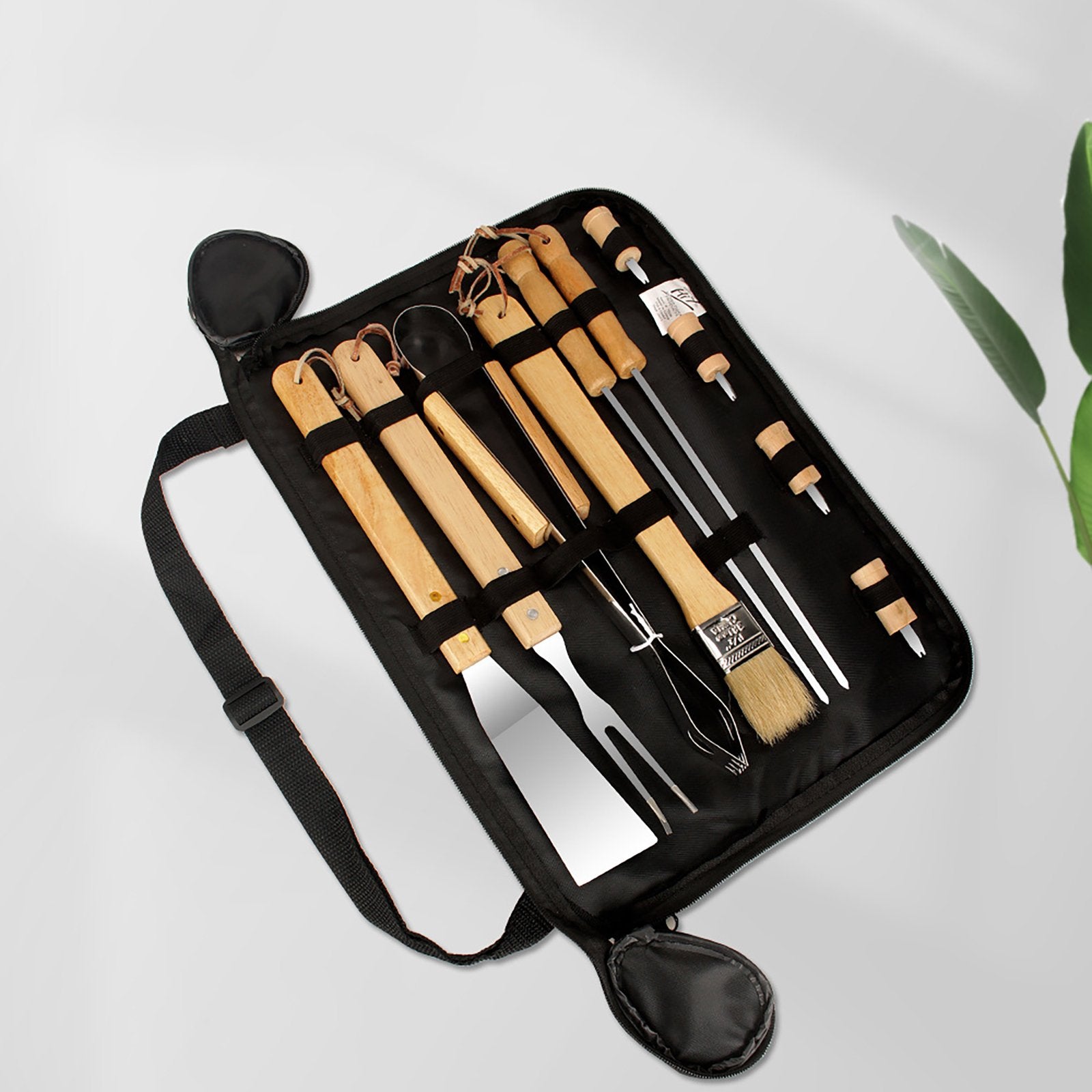 BBQ utensil set in black roll pouch, showing multiple wooden handles and metal tools