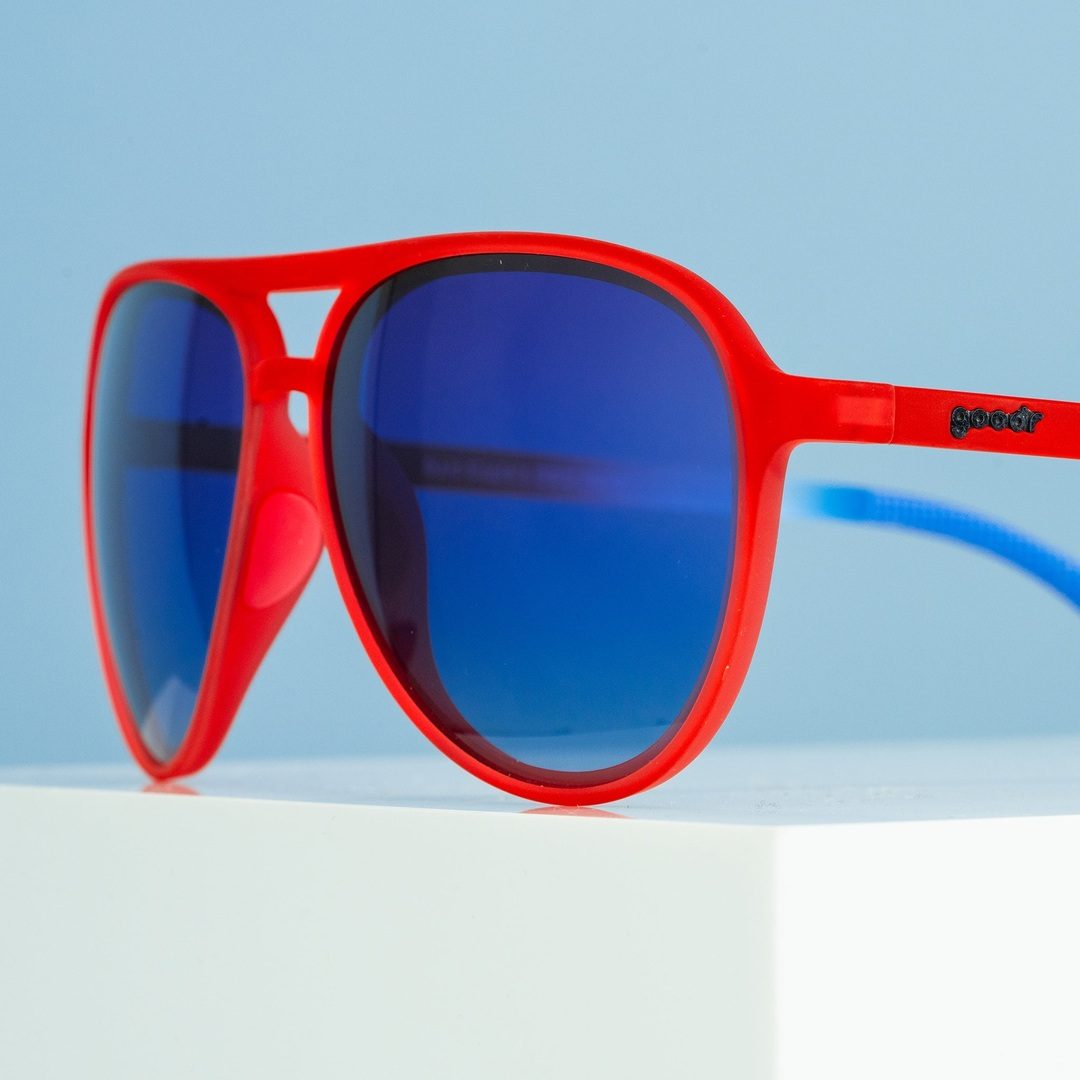 Red aviator sunglasses with blue mirrored lens, side profile with goodr logo.