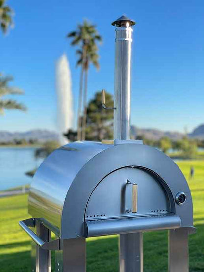 Pizza oven front view with chimney, arched door opening, and side burner stand