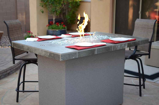 6 ft outdoor fire pit table with gray stone-look top, flames and clear fire glass