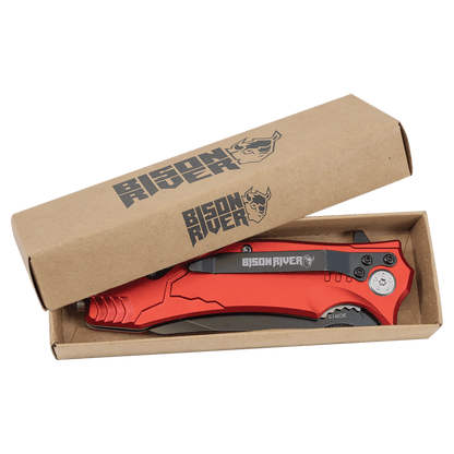 Rescue knife with red handle, partially in cardboard packaging sleeve