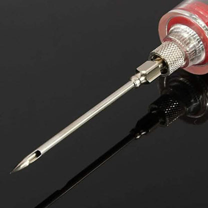 Close-up of marinade injector nozzle with red collar, threaded tip and metal needle