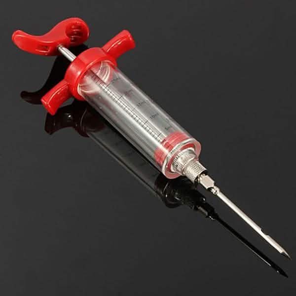 Marinade injector syringe with red control knob, clear barrel and twin needle points