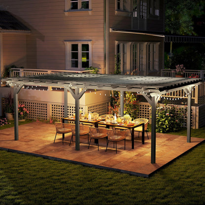 Gray wooden pergola with slatted roof over outdoor dining table at night