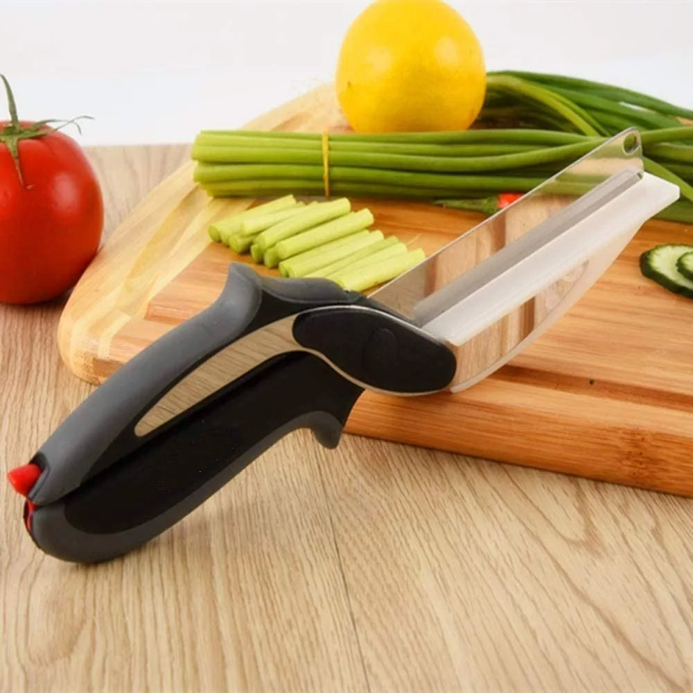 Kitchen scissors with built-in cutting board, black grips and white blade resting on wood