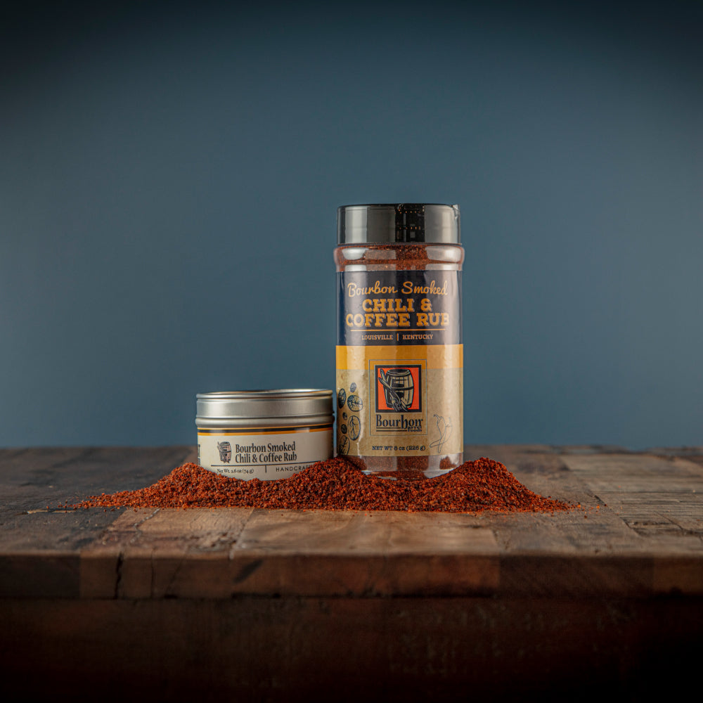 Chili and coffee rub jar with lid and red-brown spice pile on wooden board