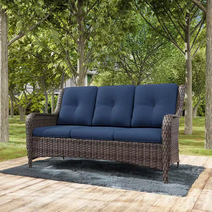 Outdoor 3-seat wicker sofa with dark blue cushions and rounded armrests