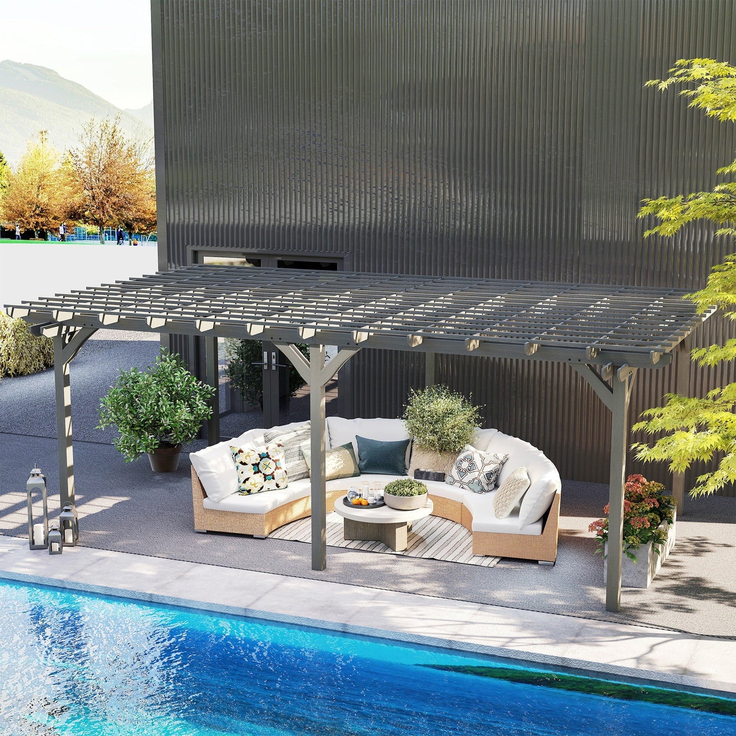 Gray wooden pergola with slatted roof over outdoor seating by a pool