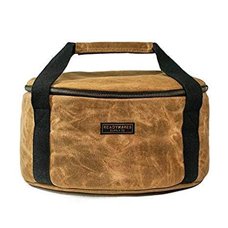 Insulated Dutch oven cover with tan top panel, black handles, and zipper