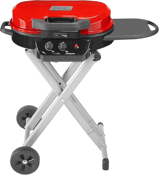 Portable propane grill with red lid, black burner panel, and two control knobs
