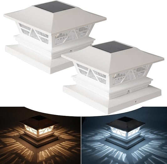 Set of two white solar fence post cap lights with black solar panels and decorative sides