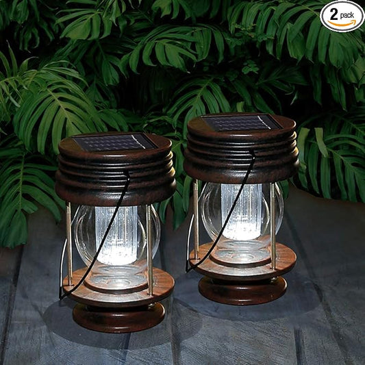 Pair of vintage solar hanging lanterns with dark metal frames and clear glass chimneys