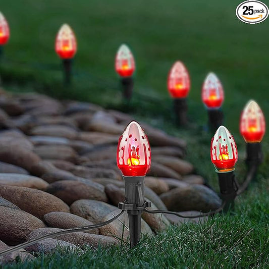 Outdoor pathway string lights with red flickering flame C9 bulbs and black stake bases