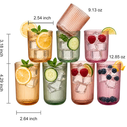 Four highball and four lowball ribbed glasses in amber, green, and pink colors