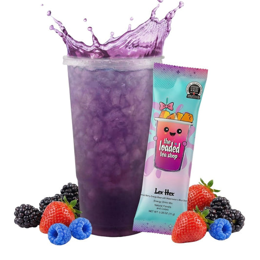 Purple loaded tea drink in clear cup with berries and a teal tea packet