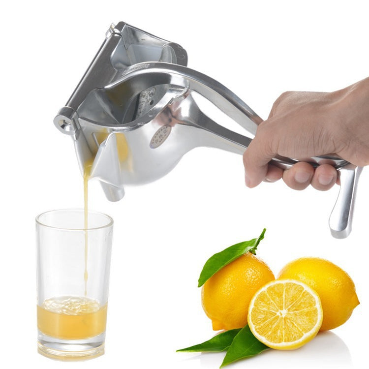 Stainless-look hand citrus juicer with lever spout pouring juice into a glass