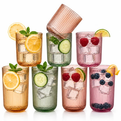 Set of 8 ribbed drinking glasses with citrus and berries in amber, green, and pink cups