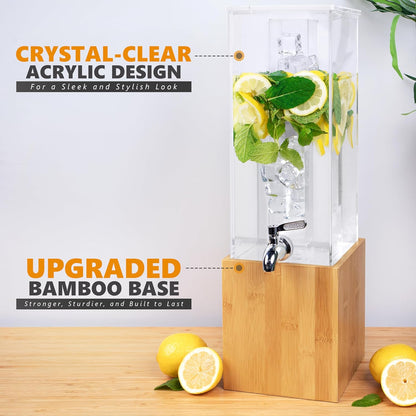Crystal-clear acrylic beverage dispenser on bamboo base with chrome spigot and citrus garnish
