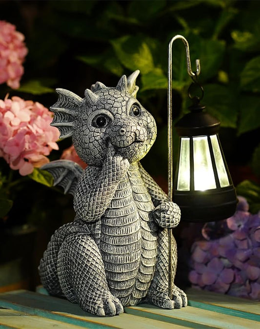 Gray dragon garden statue holding a solar lantern with warm glowing light