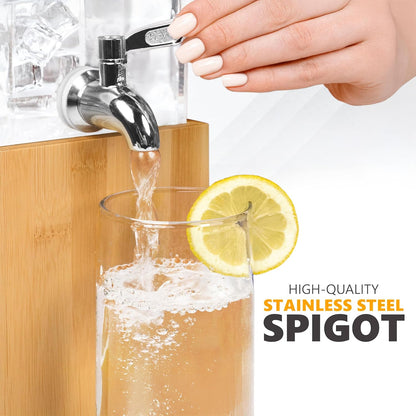 Acrylic beverage dispenser spigot with hand pouring into glass; bamboo base
