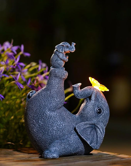 Sitting gray elephant garden statue with baby elephant, solar butterfly light accents