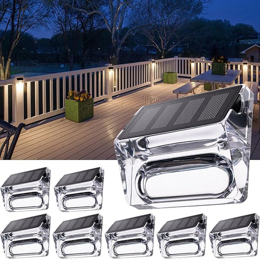 Solar fence deck lights, clear housing with solar panel and warm white LED glow.