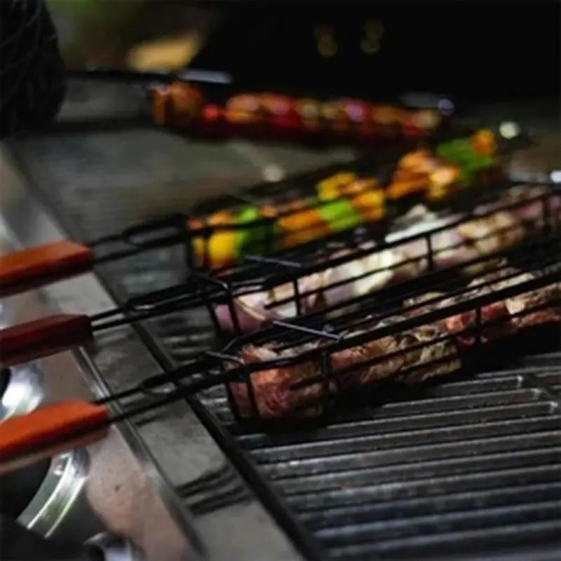 Wire grilling basket on grill grate, wooden handle extending over coals