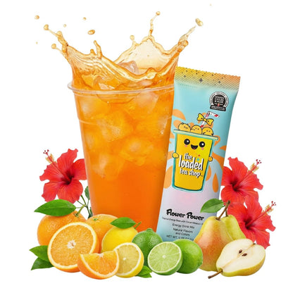 Orange loaded tea drink in clear cup with citrus slices, lime, and pear-shaped fruit