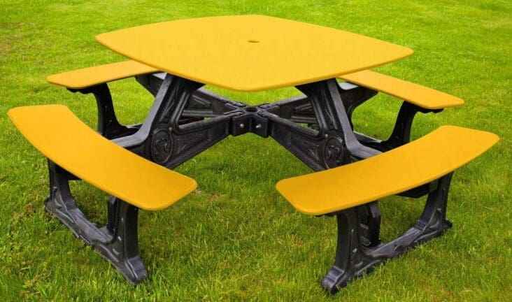 Outdoor dining table with attached benches, yellow tabletop and seats, black frame
