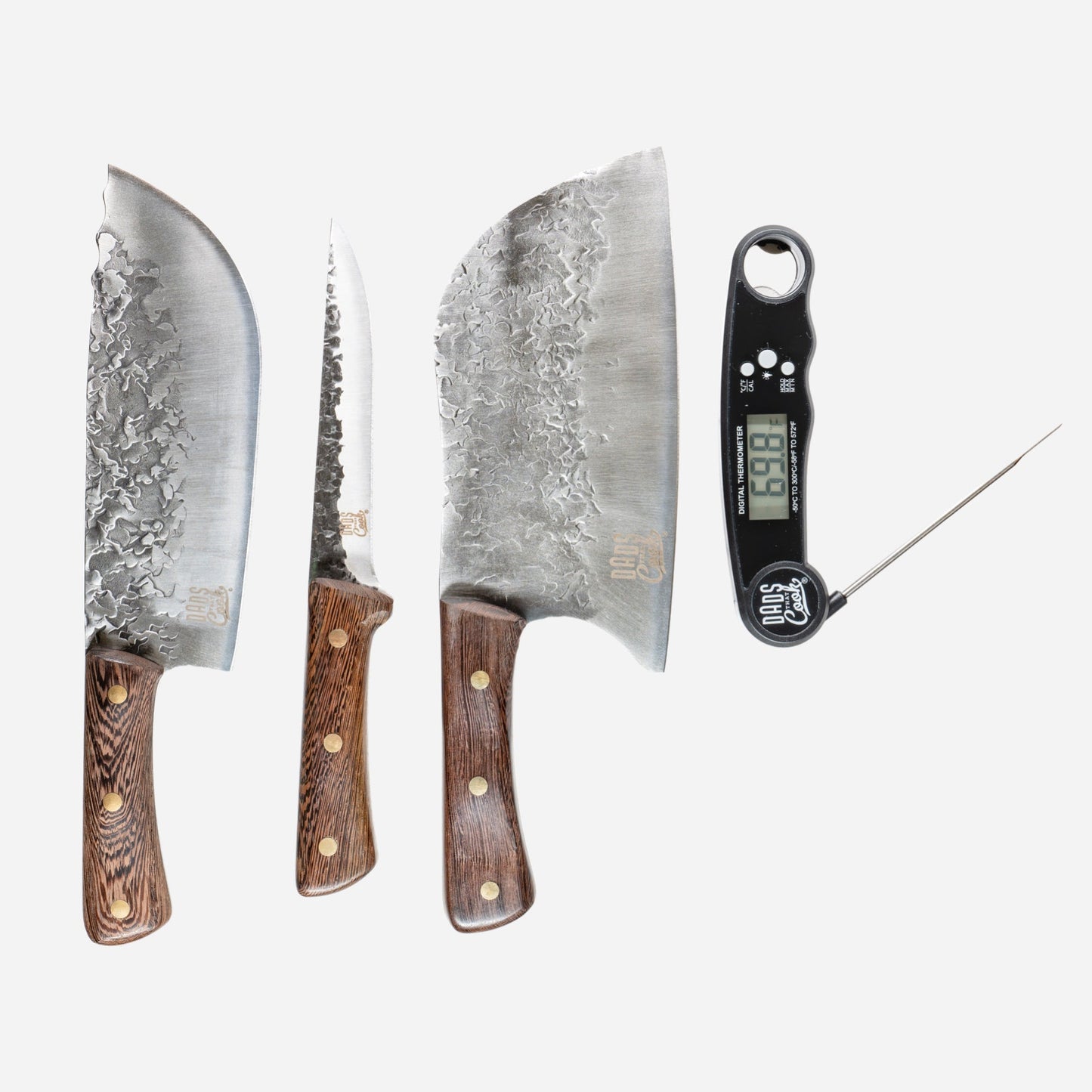Three stainless BBQ knives with wood handles and a digital thermometer on a white layout