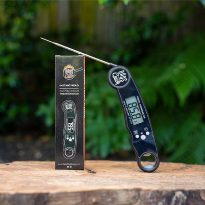 Digital instant-read thermometer with probe and retail box on a wooden surface